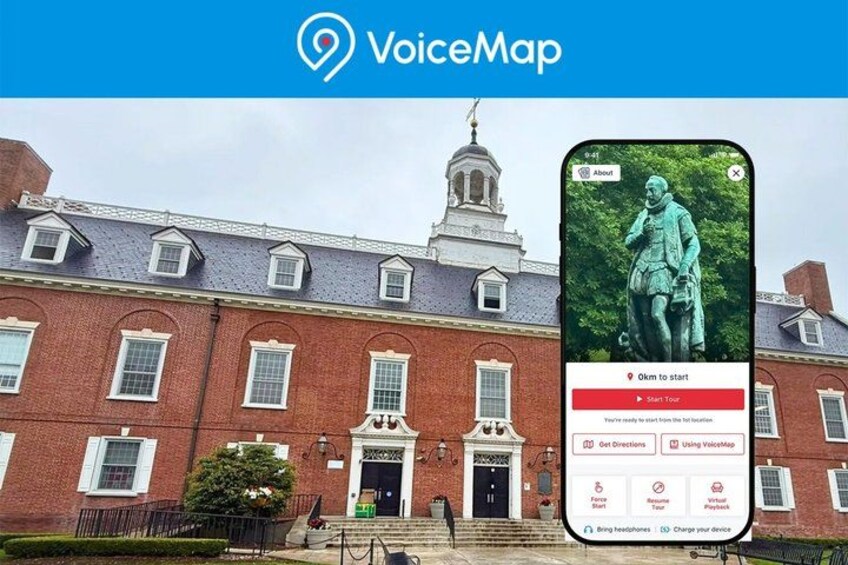 A red brick building with a statue in front, a smartphone displaying a map, and a sign indicating '9 km to start'. 1