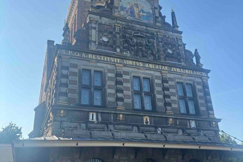 A historic building with ornate architecture and inscriptions. 1
