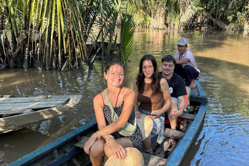 A group of people in a boat on a river surrounded by dense vegetation. 5