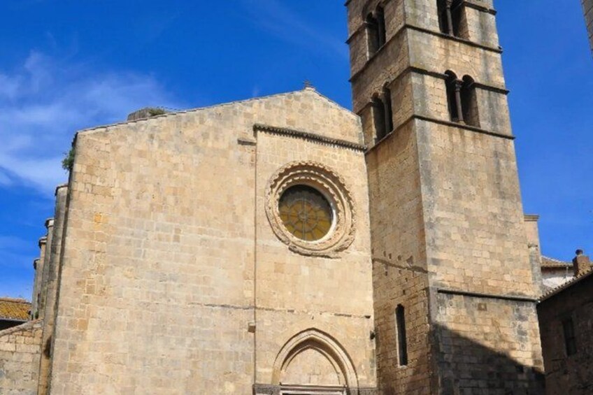A historic stone building with a clock tower and arched entrance. 4
