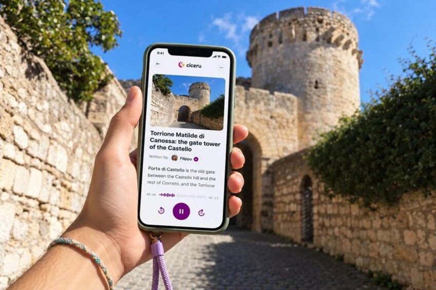 A smartphone displaying a historical article about a gate tower in Canossa. 1