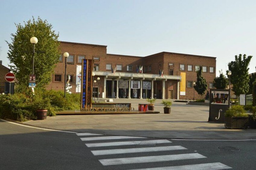 A building with a brick facade, a pedestrian crossing, and a no-entry sign. 2
