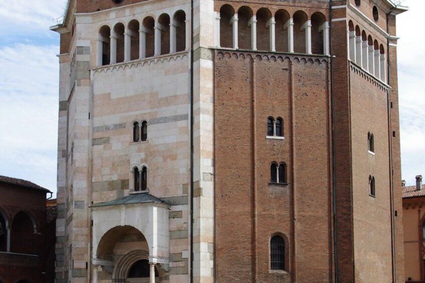 A historic building with a tall tower, arched windows, and a stone facade. 5