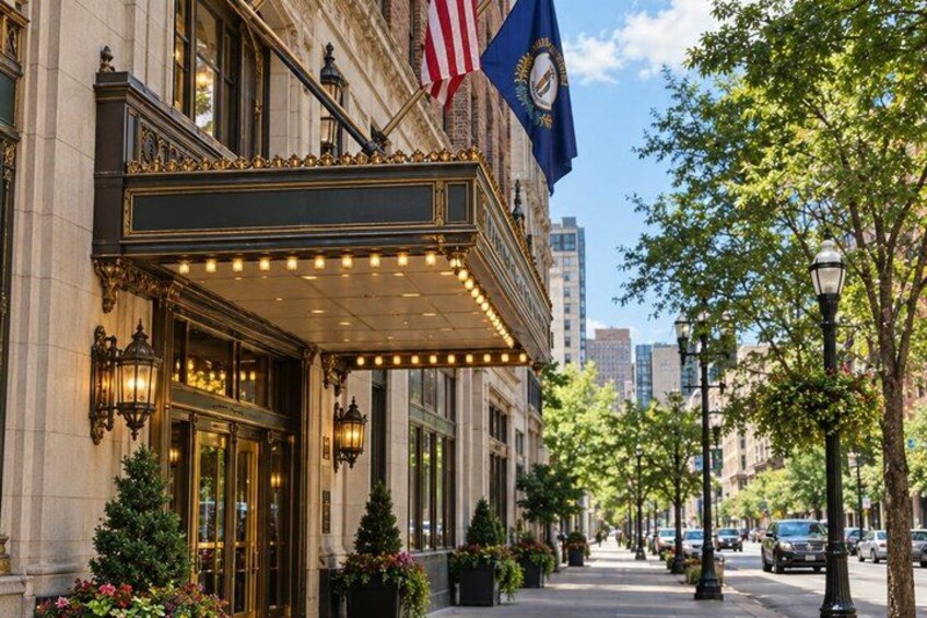 A grand building with a marquee, American flag, and a blue flag with a seal. 4