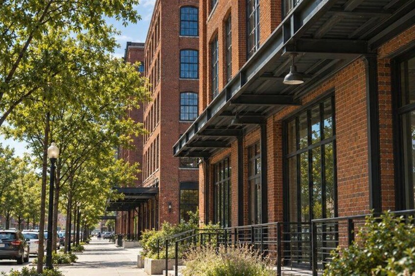 A brick building with large windows and a covered walkway. 2