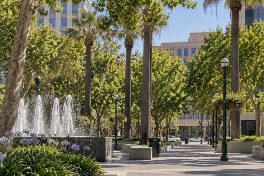 A fountain, trees, and a building in the background. 4