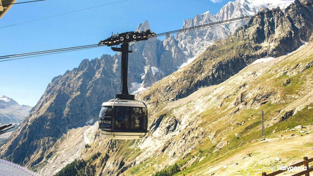 A cable car suspended over a mountainous landscape. 2