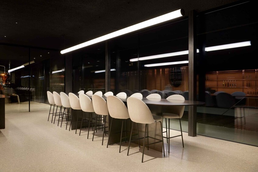 A modern dining area with a long table and multiple chairs. 4