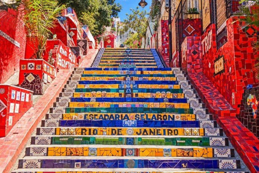 A colorful staircase with mosaic tiles and street signs. 3