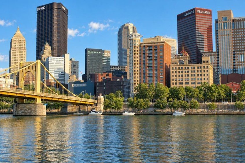 A city skyline with a prominent bridge and several high-rise buildings. 2