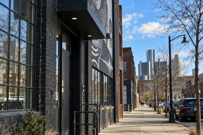 A city street with buildings, a sidewalk, and parked cars. 4