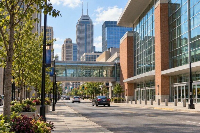 A city street with modern buildings, a clear sky, and a distant skyscraper. 5