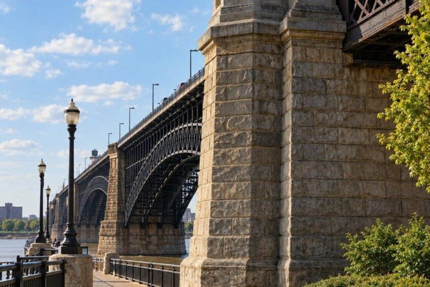 A stone bridge with arched walkways and street lamps. 3