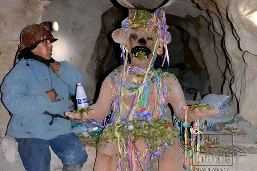 A person in a cave with colorful decorations and a bottle. 2