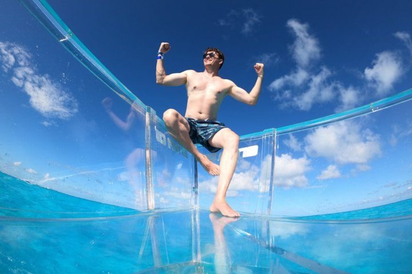 A person diving into a clear blue pool with a transparent edge. 4