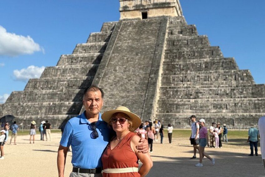 A large pyramid structure with tourists in the foreground. 5
