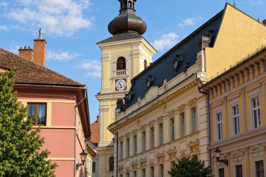 A historic building with a clock tower and a dome. 2