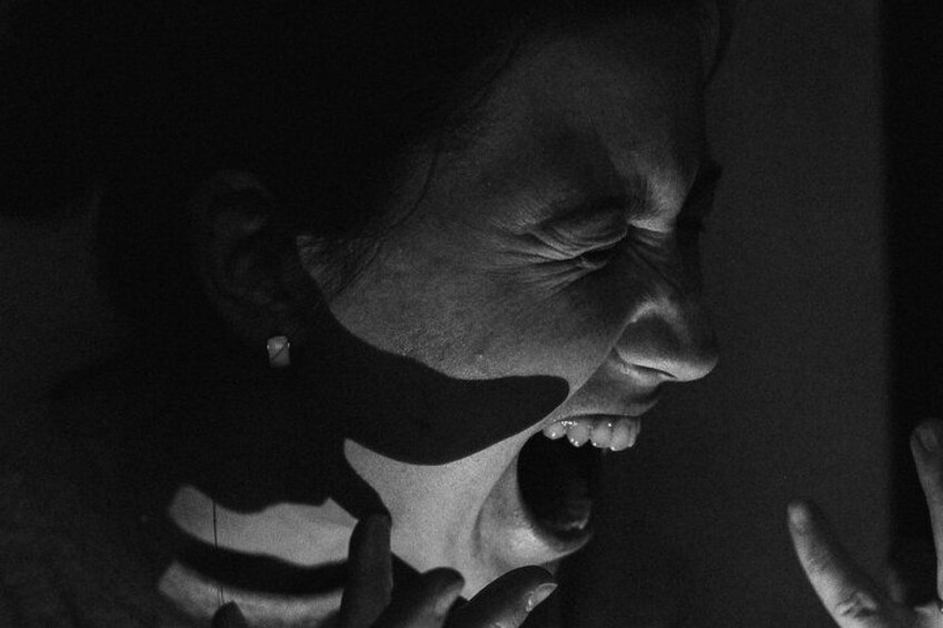 A person with a shadow cast on their face. 1