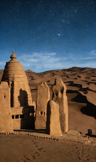Un paysage désertique avec des dunes de sable et un bâtiment traditionnel doté d’un toit conique. 3