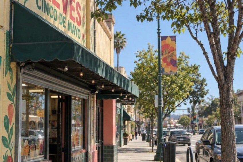 A restaurant named 'CINCO DE MAYO' with a green awning and outdoor seating. 4