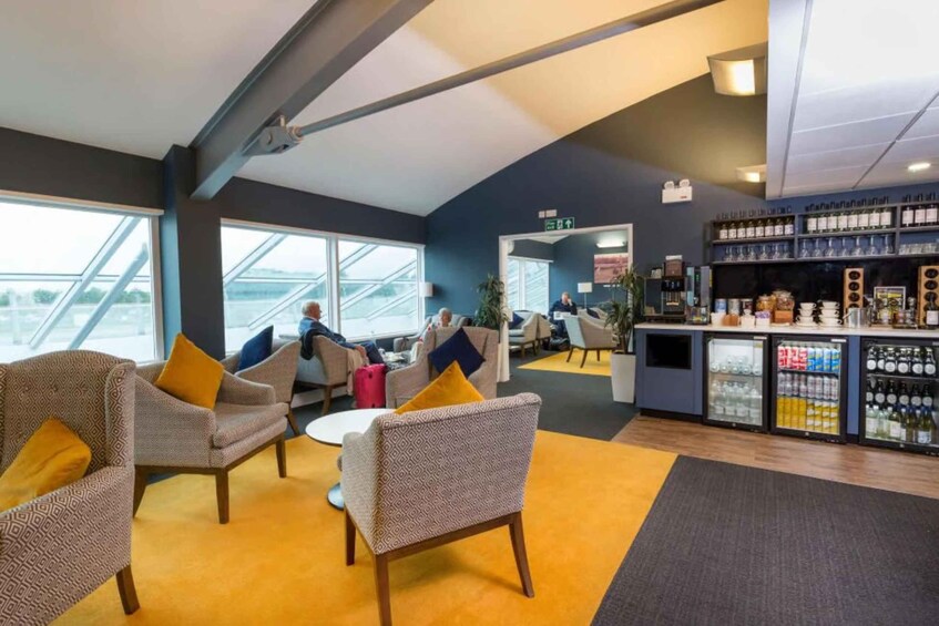A modern interior with seating, a bar area, and a view through large windows. 4