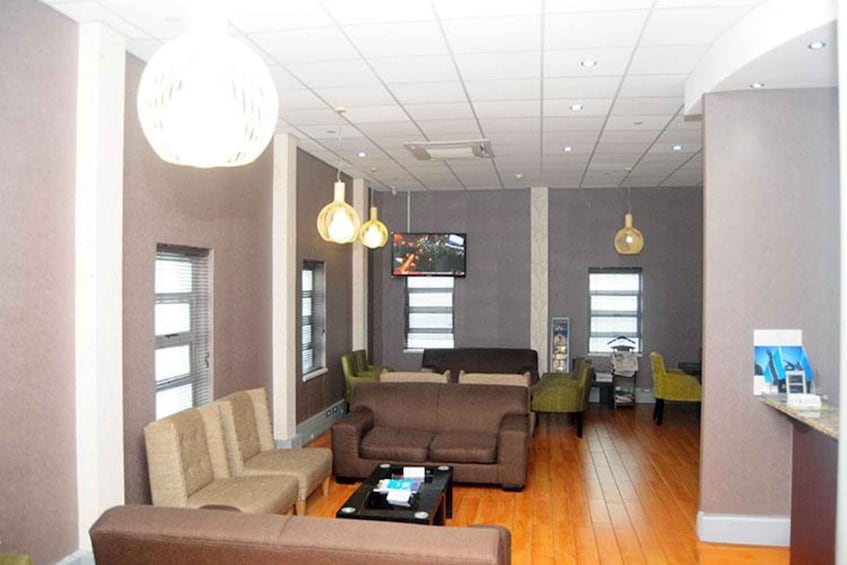 A modern living room with sofas, a coffee table, and pendant lights. 1