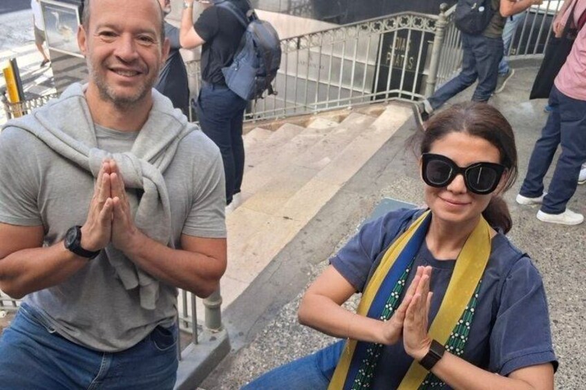 Two people sitting on steps with their hands clasped together. 5