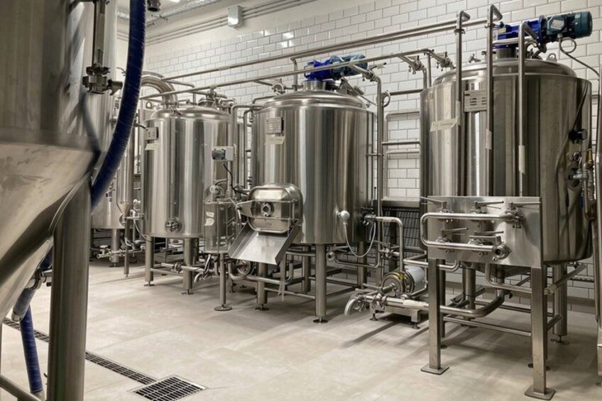 Stainless steel brewing tanks in a clean, industrial setting. 5