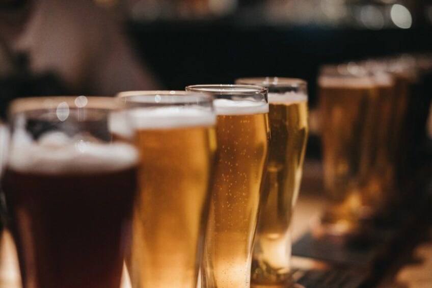 A row of beer glasses on a bar counter. 3