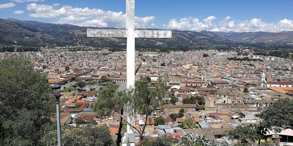 A cross with a cityscape in the background. 3