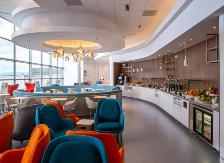 A modern interior with a curved seating area, a central bar, and a kitchen counter with fresh produce. 4