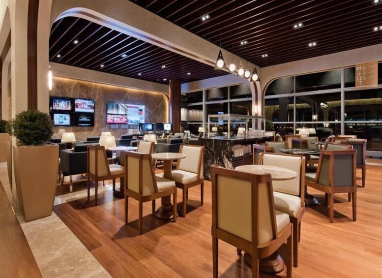 A modern interior with wooden flooring, a bar area, and seating arrangements. 2
