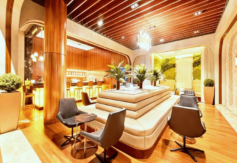 A modern interior with wooden paneling, a seating area, and a bar. 1