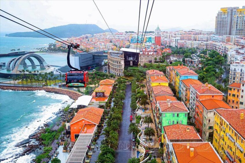 A cable car system, colorful buildings, a coastal area, and a bridge. 5