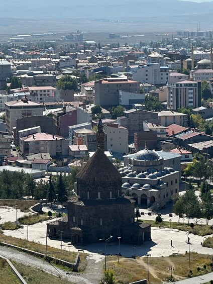 A cityscape with a prominent historical building featuring a large dome and a minaret. 5