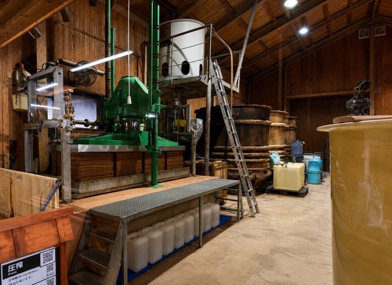A brewery with wooden interiors, large brewing equipment, and storage tanks. 5