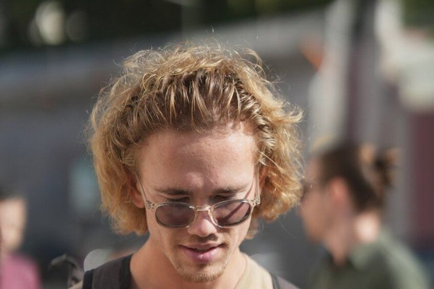 A person with curly hair and glasses. 3