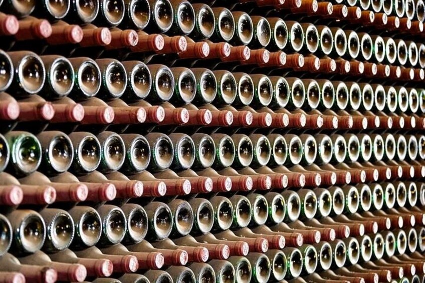 A collection of wine bottles arranged in rows. 2