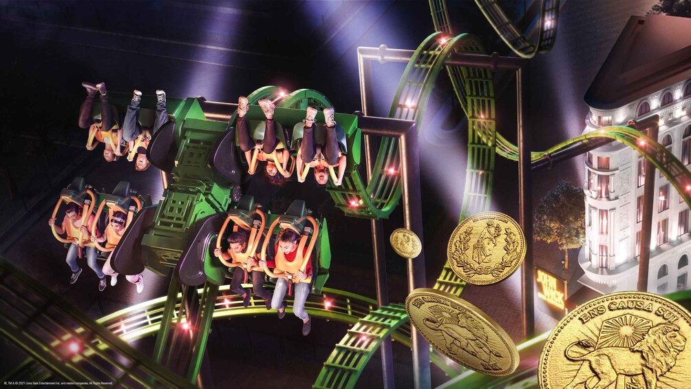 A roller coaster with green cars and riders in motion. 1