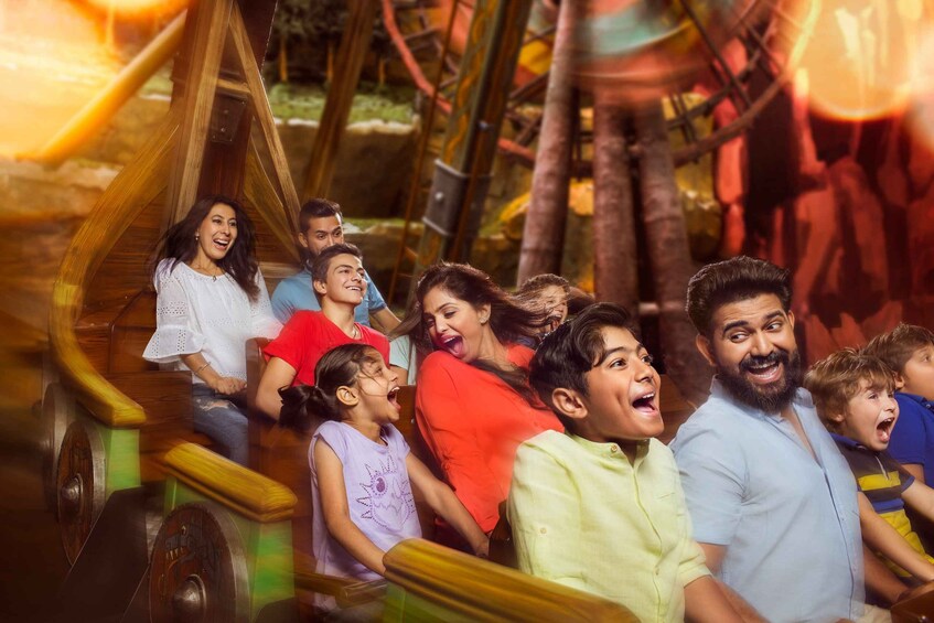 A group of people on a wooden roller coaster with a jungle theme. 5