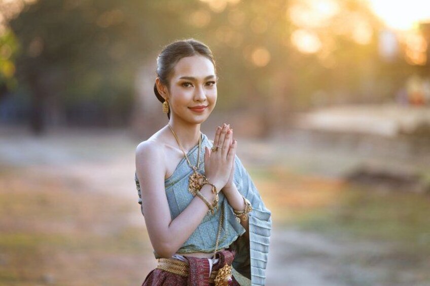A person in traditional attire with a serene outdoor setting. 3