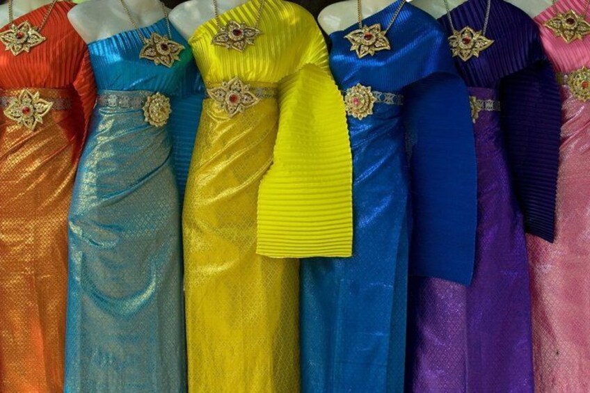 A collection of colorful dresses with intricate gold embroidery and floral designs. 2