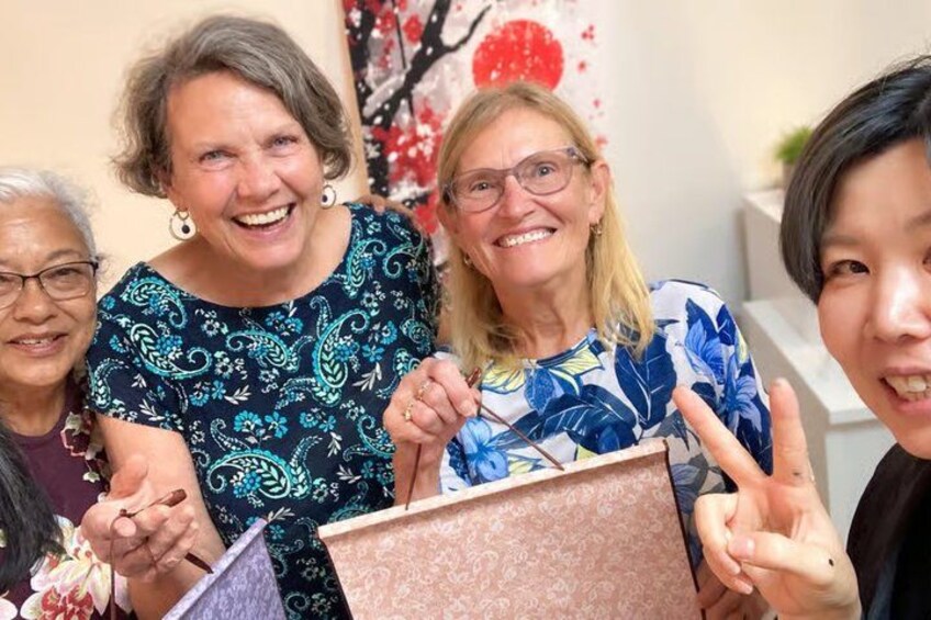 A group of people holding a gift box. 5