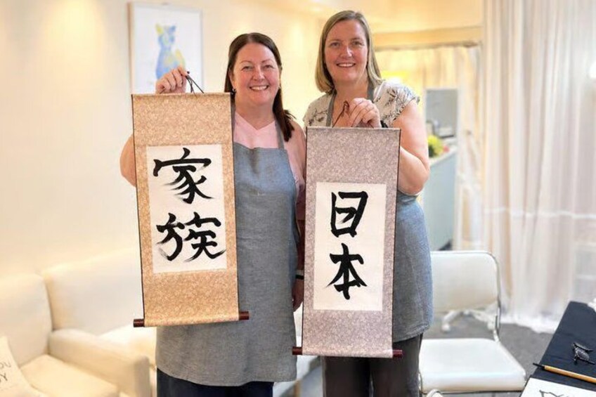 Two individuals holding rectangular signs with Japanese characters. 4