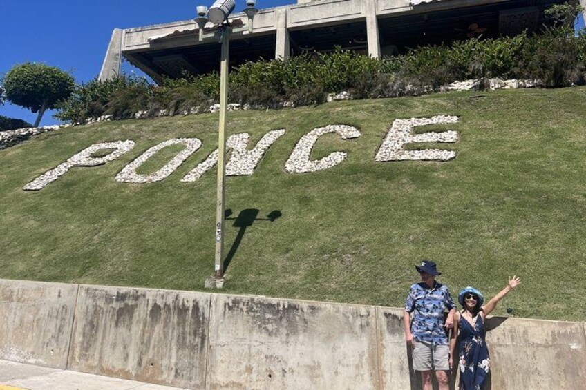 A grassy slope with the word 'PONCE' spelled out in white letters. 2