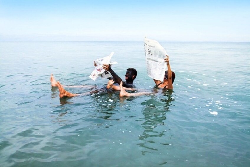 Couple floating along the Dead Sea 