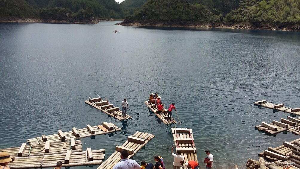 People stand on flat boats on the Montebello Lakes in Chiapas, Mexico