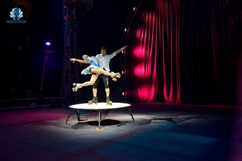 A circus performance with acrobats on a circular platform. 4