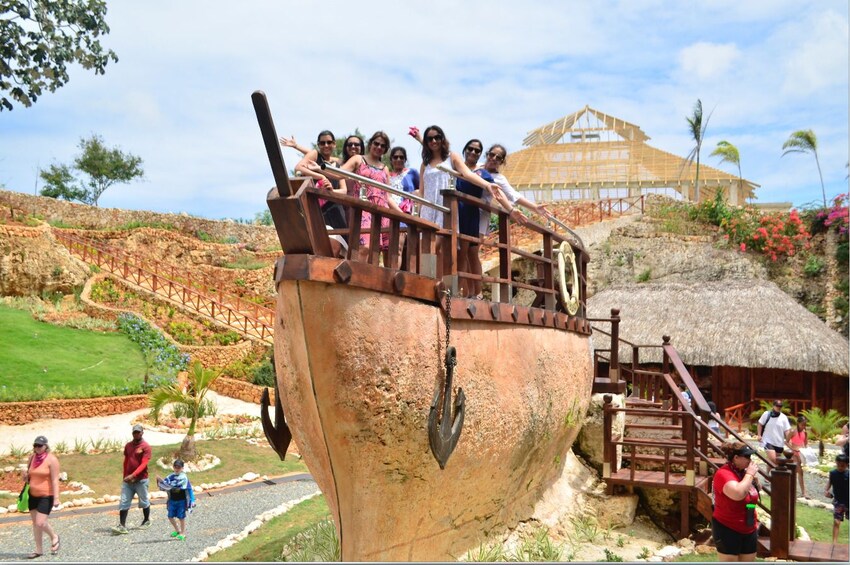 Tourists at the top on tall, clay boat on land in the Dominican Republic