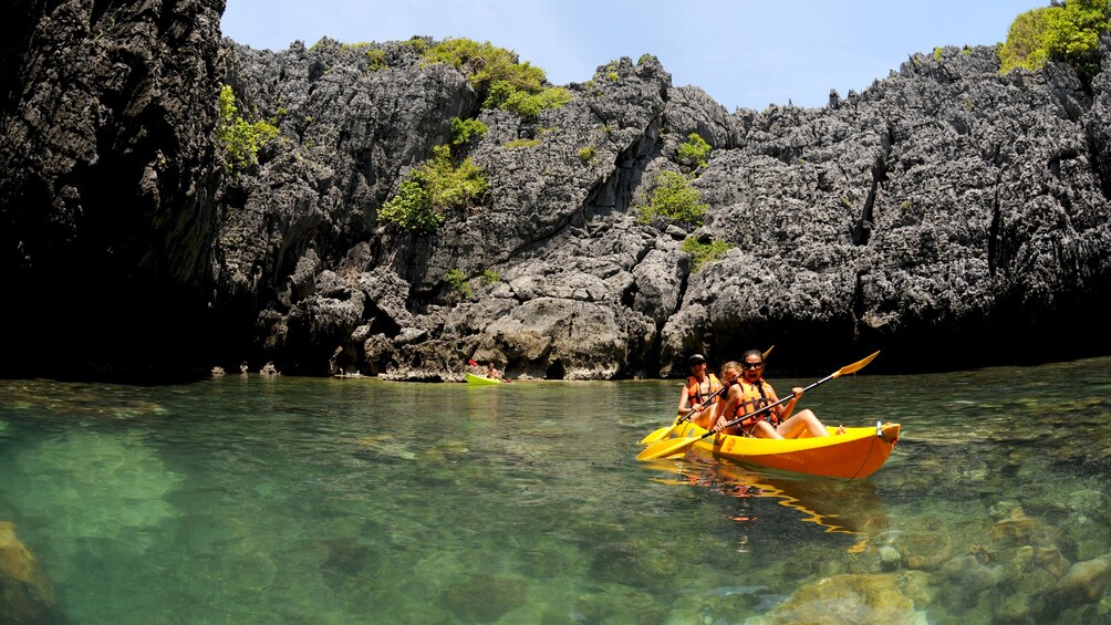 Group Sea Kayaking at Angthong National Marine Park on a sunny day 